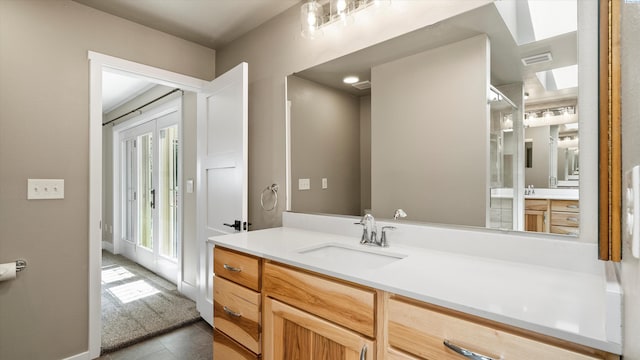 2003 W Canal Dr, Kennewick, WA 99336 - full bathroom featuring a skylight, vanity, and tile patterned floors