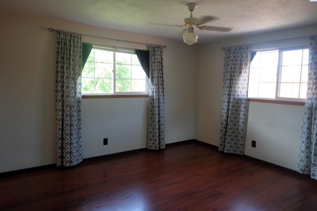 1815 W 16th Ave, Kennewick, WA 99337 - spare room featuring plenty of natural light, dark wood-style flooring, a ceiling fan, and baseboards
