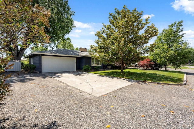 1815 W 16th Ave, Kennewick, WA 99337 - view of front facade with concrete driveway, an attached garage, a front yard, and a chimney
