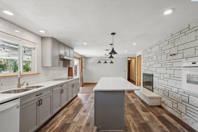 1815 W 16th Ave, Kennewick, WA 99337 - kitchen featuring gray cabinetry, white appliances, a center island, under cabinet range hood, and dark wood finished floors