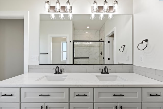 bathroom with a sink, double vanity, and a stall shower