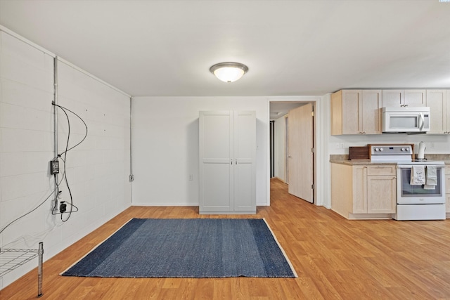 kitchen featuring white appliances, light brown cabinetry, and light hardwood / wood-style flooring