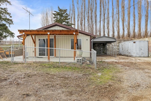 view of side of home with a carport