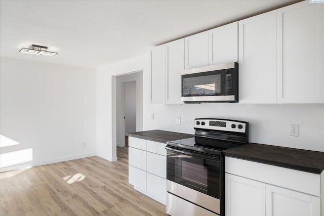 kitchen featuring appliances with stainless steel finishes, white cabinetry, and light wood-style flooring