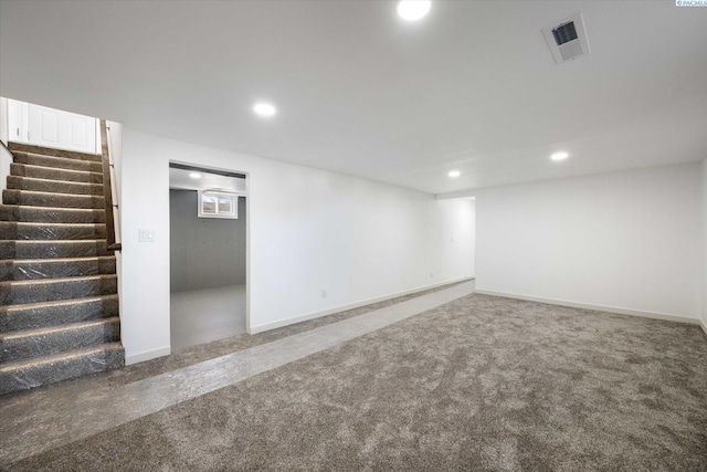 finished basement with carpet floors, recessed lighting, visible vents, and stairs