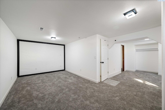 carpeted home theater featuring visible vents and baseboards