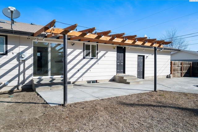 rear view of property featuring a patio area, fence, and a pergola