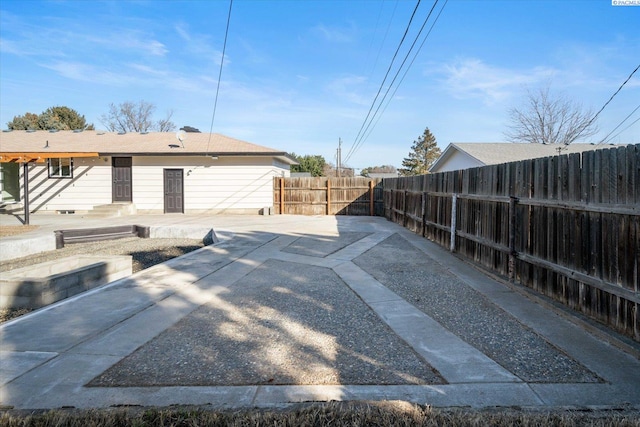 exterior space with entry steps and a fenced backyard