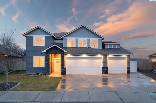 view of front of property featuring a garage and a lawn