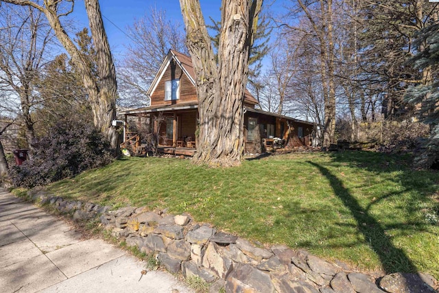 view of side of home with a yard