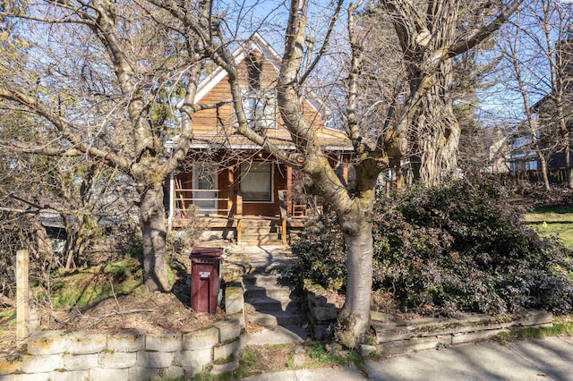 obstructed view of property with covered porch