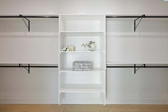 walk in closet featuring wood finished floors