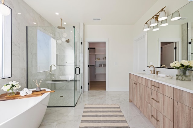 full bath featuring visible vents, vanity, a freestanding bath, marble finish floor, and a marble finish shower