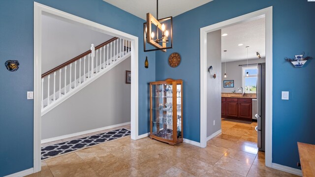 2876 Crosswater Loop, Richland, WA 99354 - foyer entrance featuring a chandelier, stairs, and baseboards