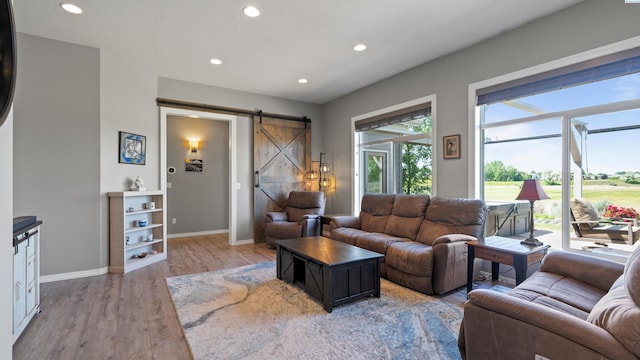 2876 Crosswater Loop, Richland, WA 99354 - living room featuring a barn door, light wood-type flooring, baseboards, and recessed lighting