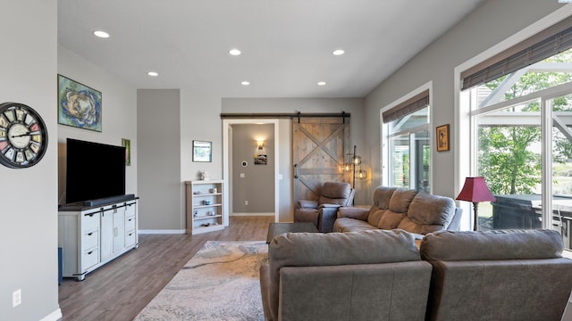 2876 Crosswater Loop, Richland, WA 99354 - living room featuring a barn door, wood finished floors, healthy amount of natural light, recessed lighting, and baseboards