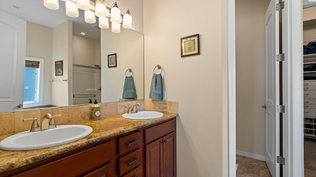 2876 Crosswater Loop, Richland, WA 99354 - bathroom with a walk in closet, double vanity, and a stall shower