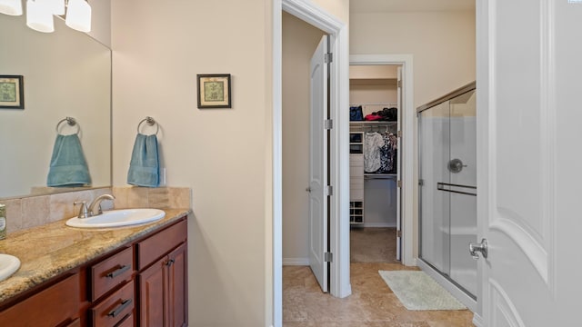 2876 Crosswater Loop, Richland, WA 99354 - bathroom featuring a stall shower, a spacious closet, and double vanity