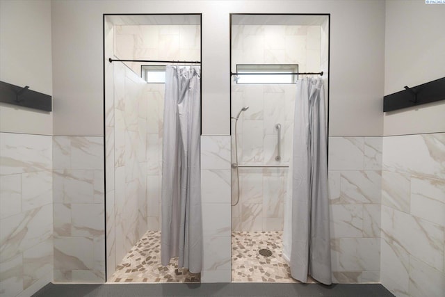 bathroom featuring tile walls and walk in shower