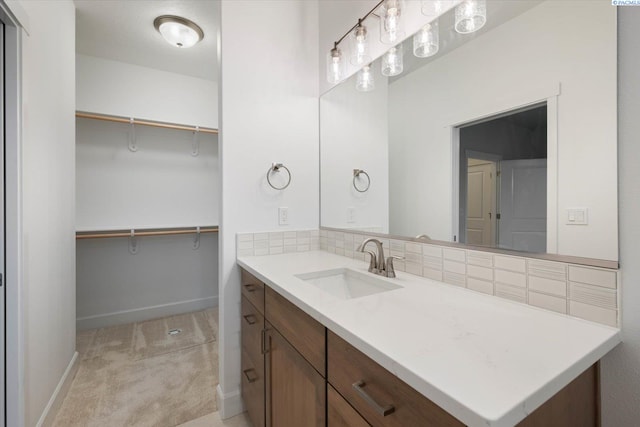 bathroom featuring tasteful backsplash and vanity