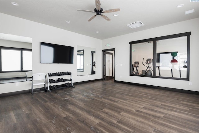 living room with ceiling fan, a wealth of natural light, and dark hardwood / wood-style flooring