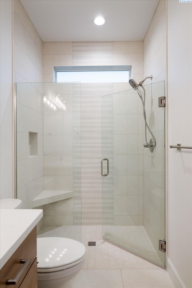 bathroom with a healthy amount of sunlight, vanity, and a shower with door