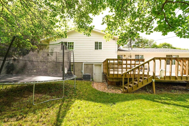 610 Dilke St, Pullman, WA 99163 - back of property with a trampoline, a lawn, and a deck