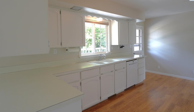 610 Dilke St, Pullman, WA 99163 - kitchen featuring white dishwasher, white cabinets, light wood-style flooring, and light countertops