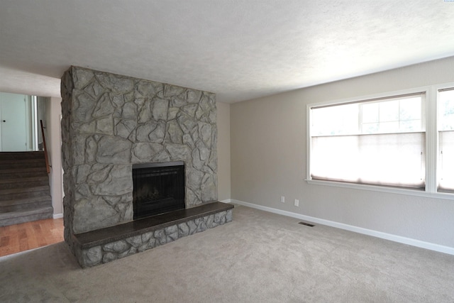 610 Dilke St, Pullman, WA 99163 - unfurnished living room featuring plenty of natural light, a fireplace, stairway, and carpet