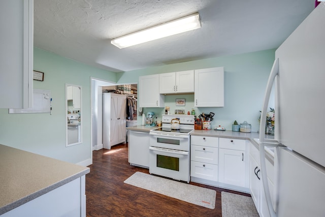 110 W Cannon St, Palouse, WA 99161 - kitchen with white appliances, dark wood finished floors, white cabinetry, light countertops, and baseboards
