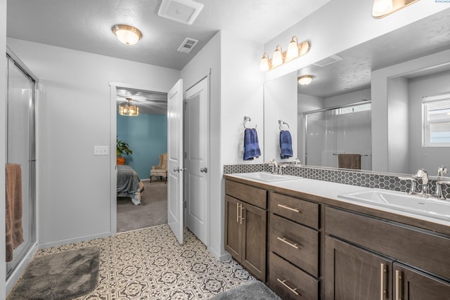 6217 Sidon Ln, Pasco, WA 99301 - ensuite bathroom featuring a shower stall, double vanity, and baseboards