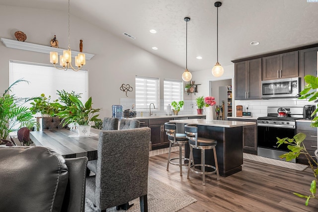 6217 Sidon Ln, Pasco, WA 99301 - dining room with a chandelier, recessed lighting, dark wood-style flooring, and high vaulted ceiling
