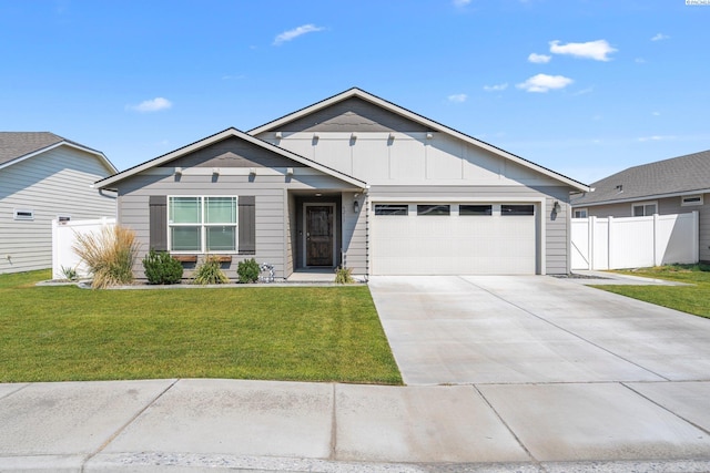 6217 Sidon Ln, Pasco, WA 99301 - view of front of house featuring a garage, driveway, and board and batten siding
