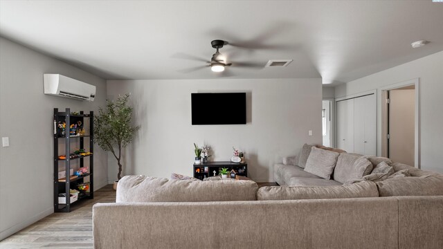 520 Whitefish Ln, Pasco, WA 99301 - living area with an AC wall unit, light wood finished floors, and a ceiling fan