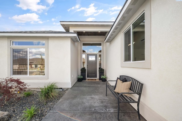property entrance with stucco siding