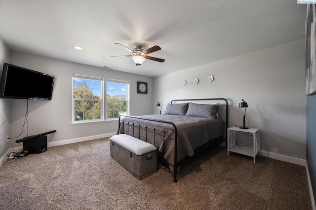 carpeted bedroom featuring baseboards and a ceiling fan