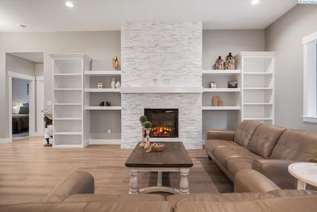 living room with hardwood / wood-style flooring and a fireplace