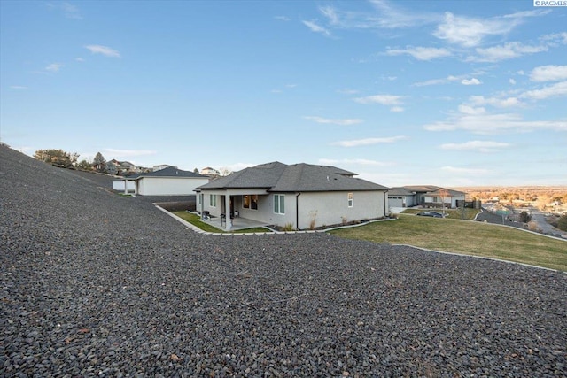 view of home's exterior with a patio and a lawn