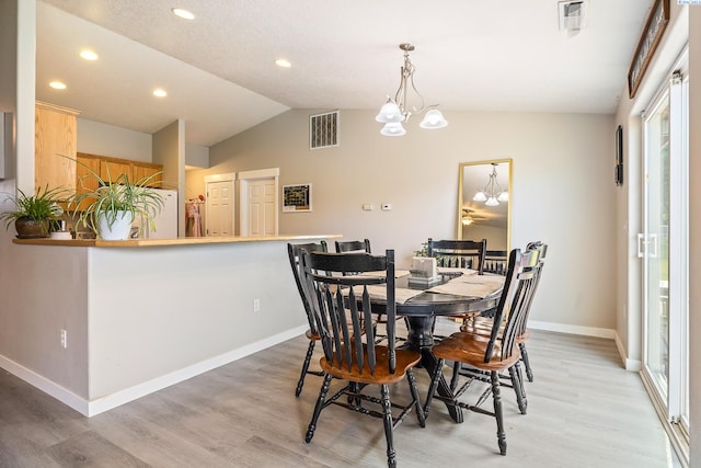 1716 W 40th Ave, Kennewick, WA 99337 - dining area featuring a chandelier, light wood-style floors, vaulted ceiling, healthy amount of natural light, and recessed lighting
