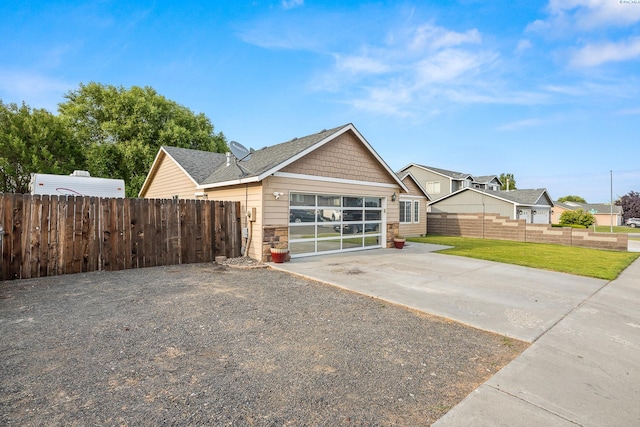 1716 W 40th Ave, Kennewick, WA 99337 - view of front facade featuring stone siding, a garage, and driveway