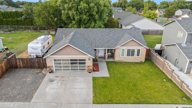 1716 W 40th Ave, Kennewick, WA 99337 - view of front facade featuring roof with shingles, driveway, an attached garage, a residential view, and a fenced backyard