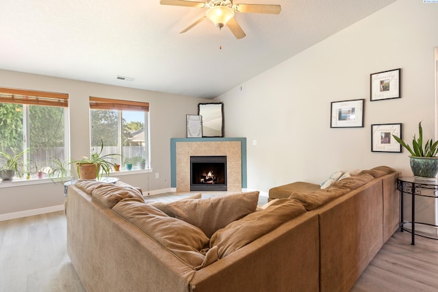 1716 W 40th Ave, Kennewick, WA 99337 - living room with light wood finished floors, ceiling fan, a fireplace, and vaulted ceiling