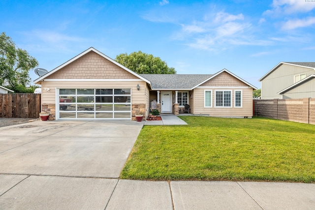 1716 W 40th Ave, Kennewick, WA 99337 - view of front of property featuring concrete driveway, a garage, and stone siding