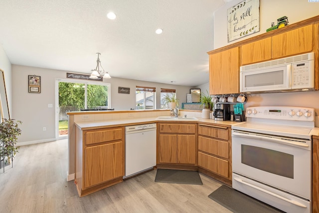 1716 W 40th Ave, Kennewick, WA 99337 - kitchen with white appliances, a peninsula, light wood-style floors, light countertops, and recessed lighting