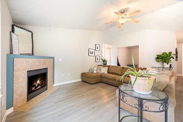 1716 W 40th Ave, Kennewick, WA 99337 - living room featuring a ceiling fan, lofted ceiling, light wood-style floors, and a tiled fireplace