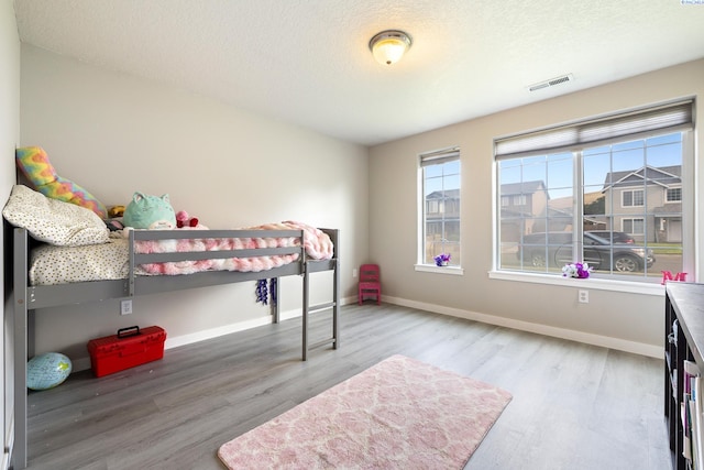 1716 W 40th Ave, Kennewick, WA 99337 - bedroom with wood finished floors and a textured ceiling
