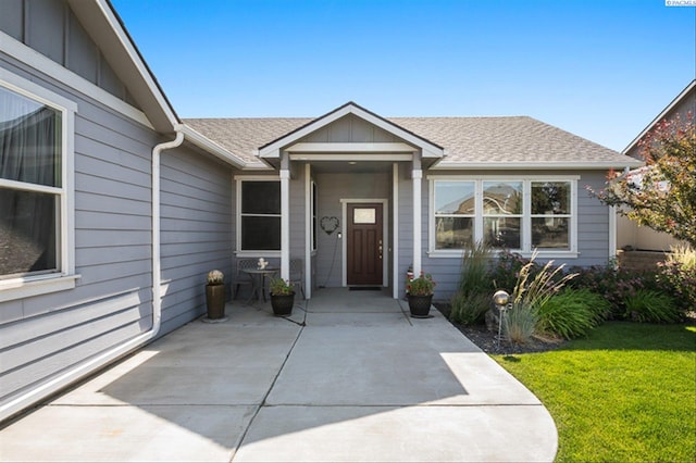 3763 S Sherman St, Kennewick, WA 99338 - property entrance featuring a shingled roof, a lawn, and board and batten siding