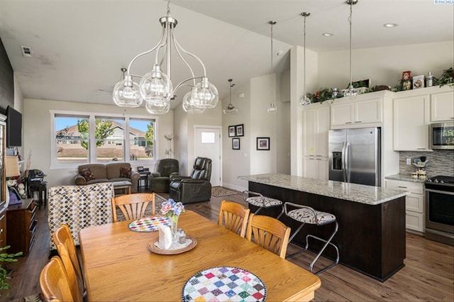 3763 S Sherman St, Kennewick, WA 99338 - dining space with dark wood-style flooring, high vaulted ceiling, and recessed lighting
