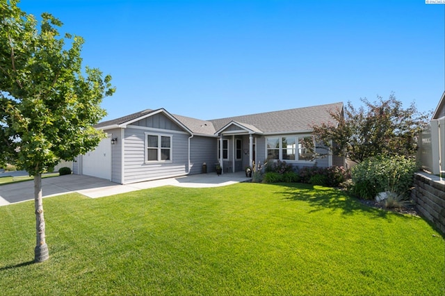 3763 S Sherman St, Kennewick, WA 99338 - ranch-style home featuring board and batten siding, a garage, a front lawn, and concrete driveway