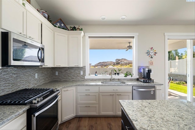 3763 S Sherman St, Kennewick, WA 99338 - kitchen featuring stainless steel appliances, backsplash, dark wood finished floors, white cabinets, and light stone countertops